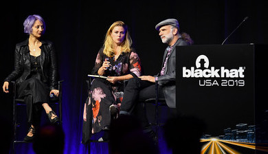 Photograph of a panel at Black Hat